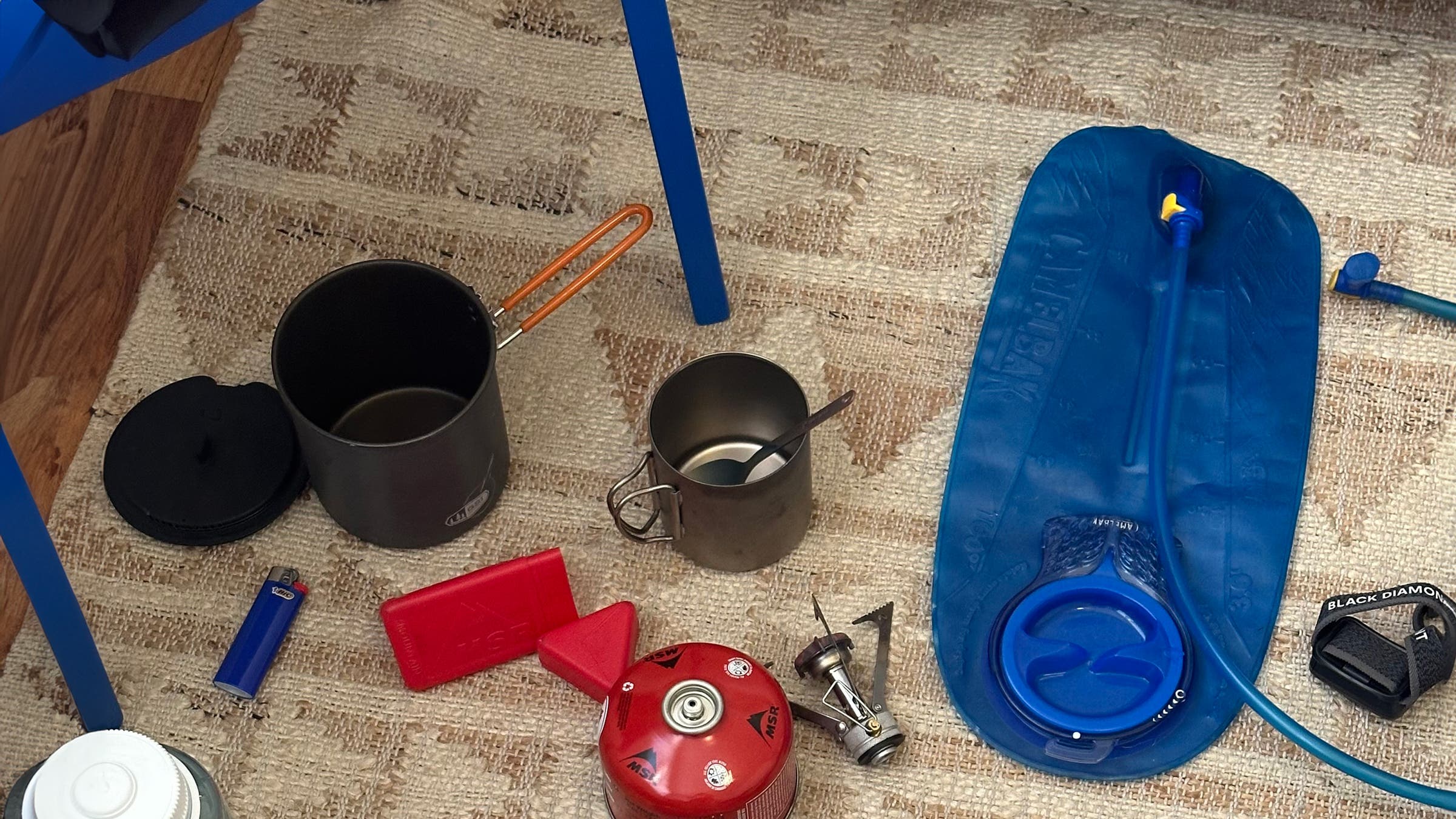 Amelia Arvesen lays out some of her tried and true backpacking gear, including her first ever titanium camp mug gifted for her first backpacking trip in 2016.