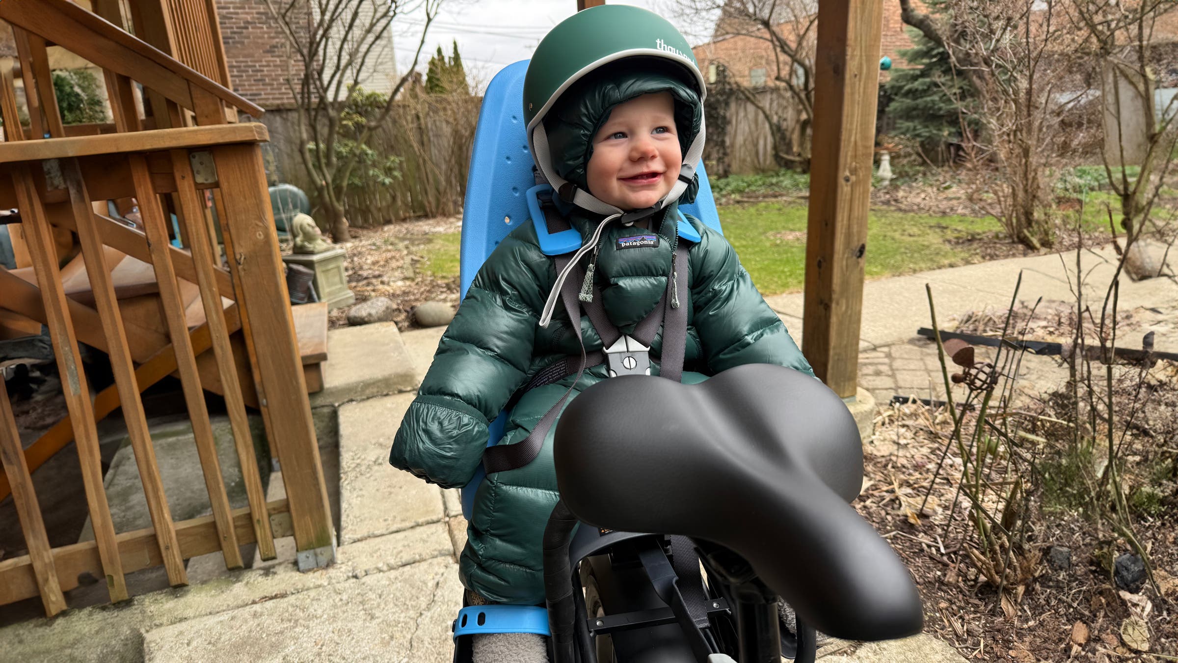 Baby in Thule Yepp bike carrier on back of Aventon Abound SR e-bike