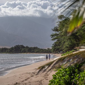 Two people walking on Sugar Beach in Kihei, Maui, Hawaii.
