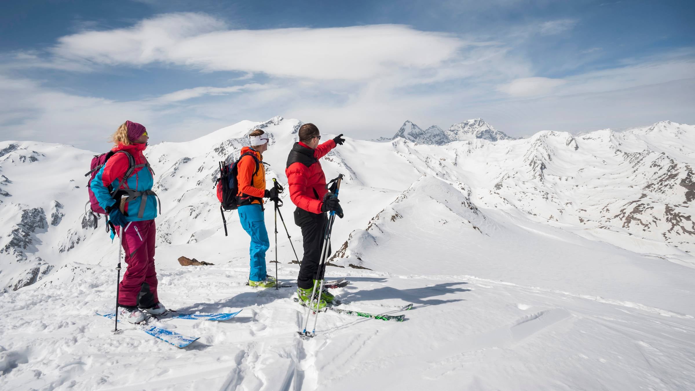 A guide with skiers in the Alps.