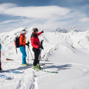 A guide with skiers in the Alps.