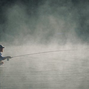 Fisherman casting in Morning Mist