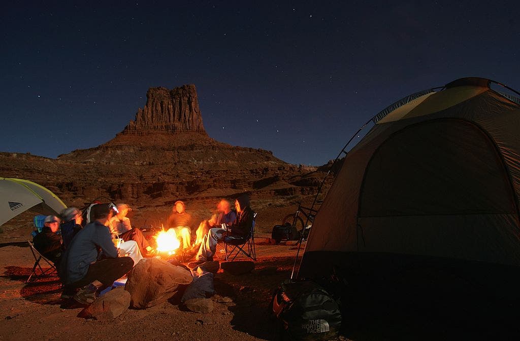 Guys sitting around a campfire