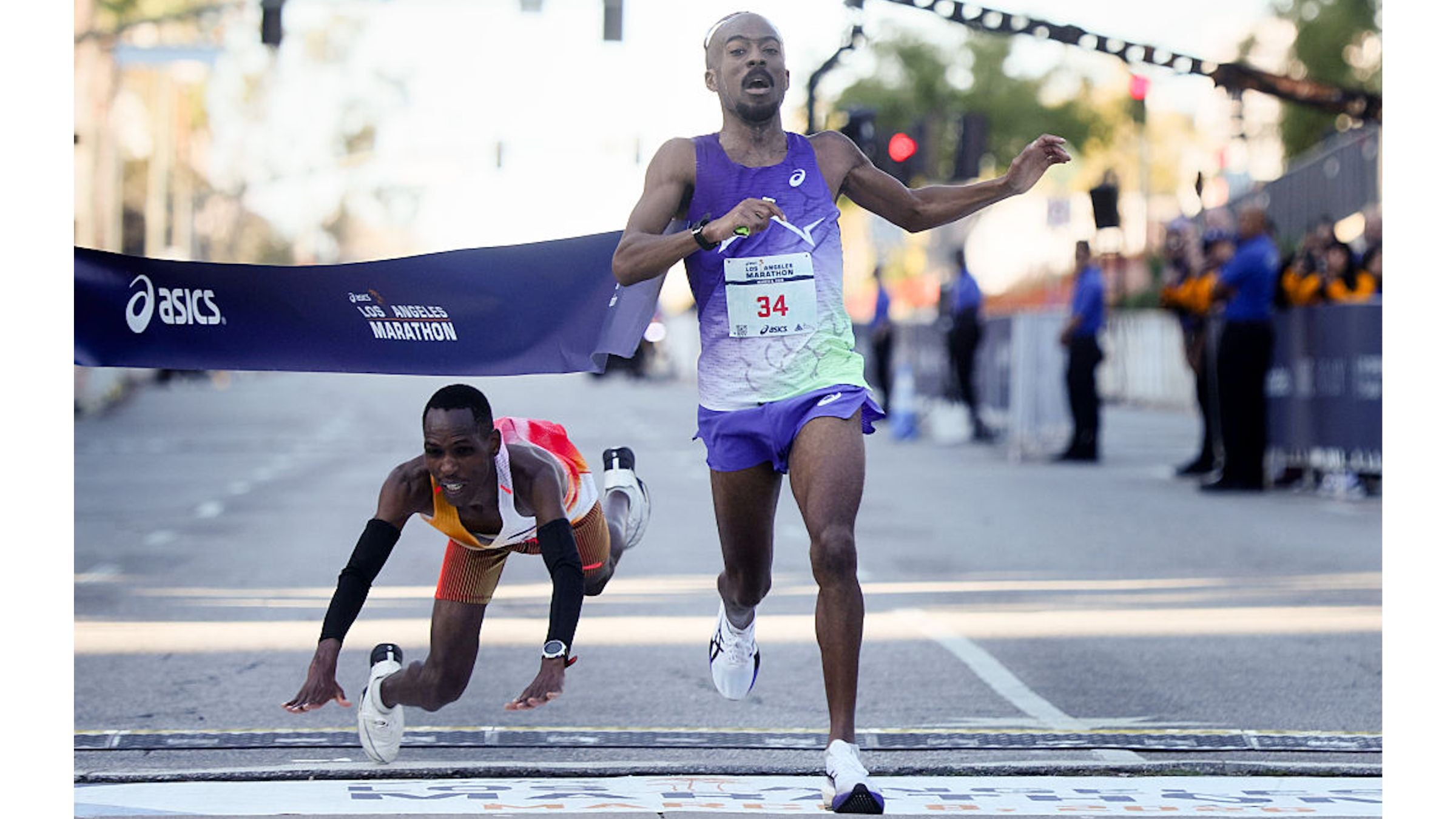 Nathan Martin crosses the finish line to place first with a time of 2:11:16.50 on a last-second sprint as Kenya's Michael Kimani Kamau dives and falls to the pavement during the 2026 Los Angeles Marathon