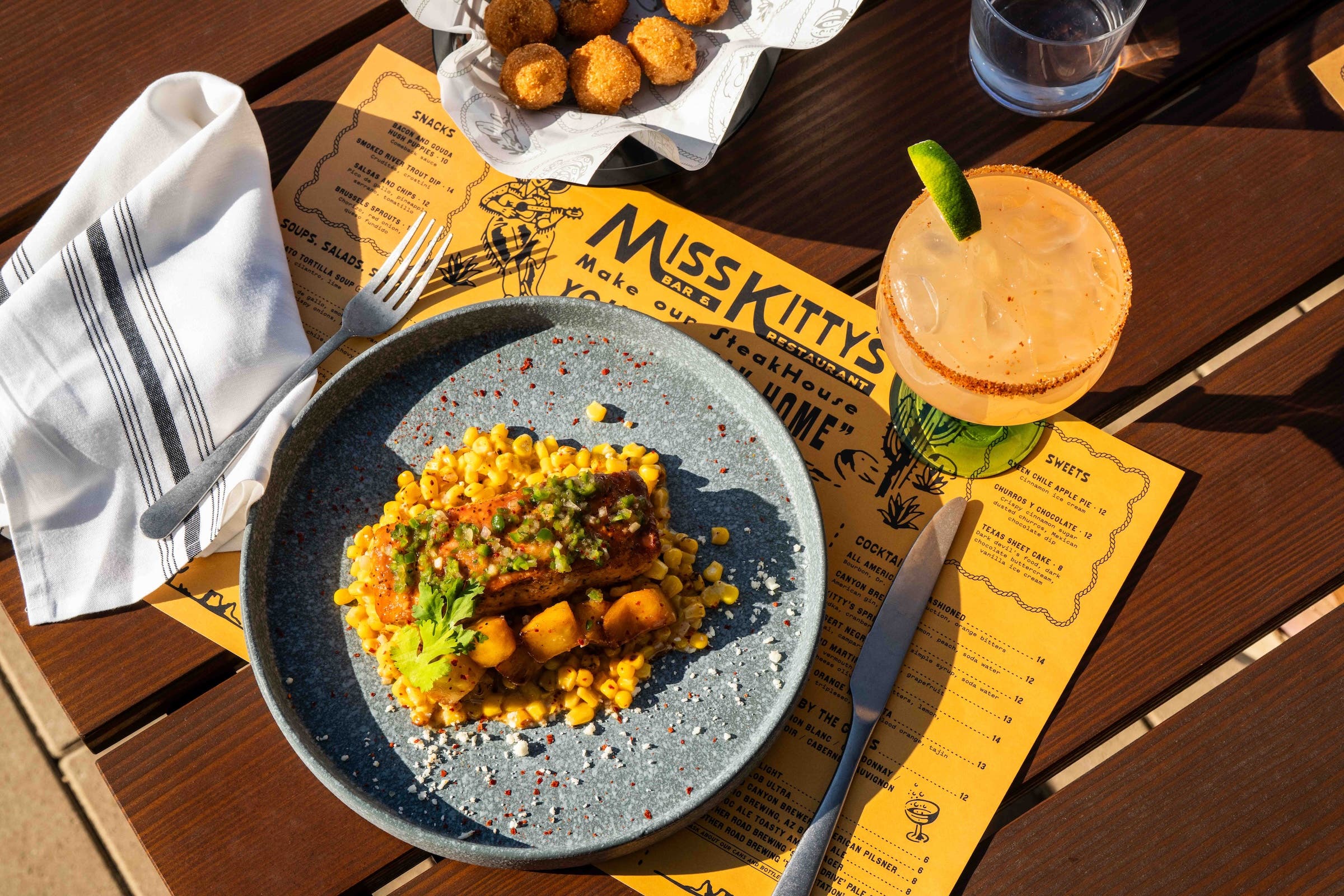 overhead food of a plate of food and margarita at Miss Kitty's