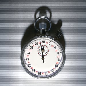 A stopwatch on a gray background.