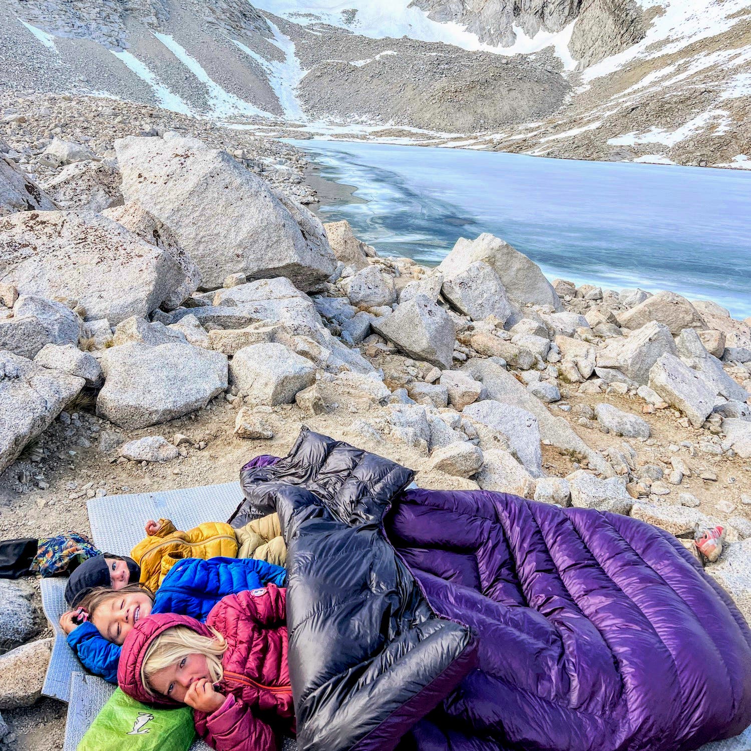 Sequoia, Joshua, and Standa Daley snuggled under a sleeping bag