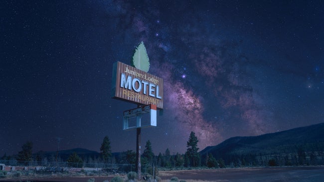 Abandoned motel sign in front of a clear night sky with the Milky Way.