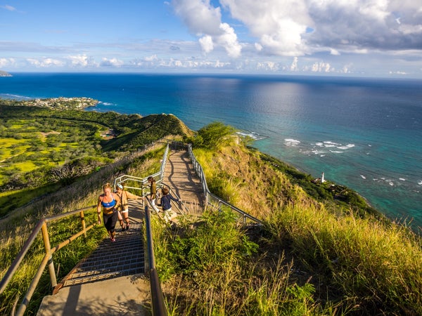People running the Trail to Diamond Head Crater, Oahu, Hawaii, one of the most scenic running trails in the U.S.
