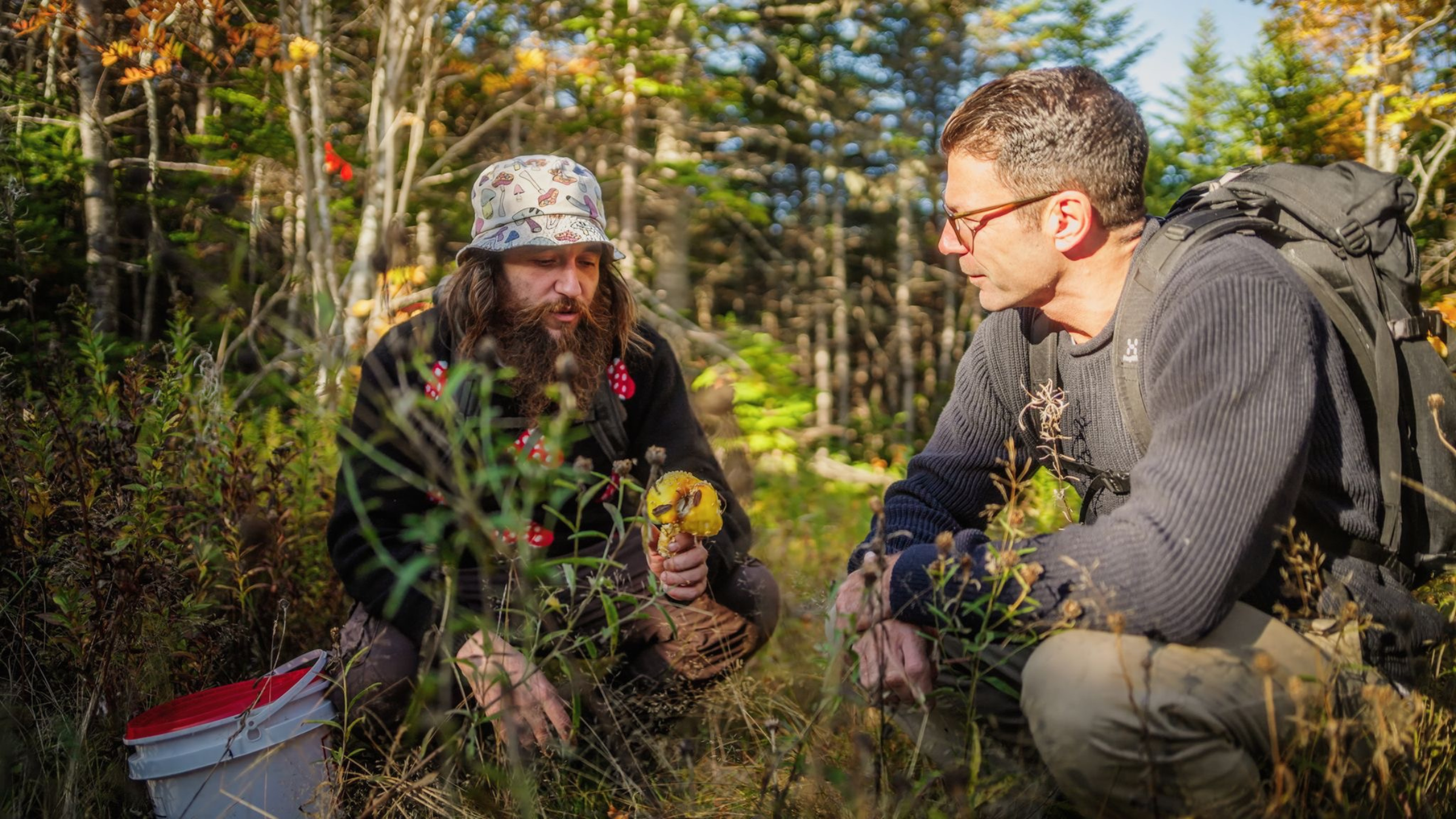 Josh Rosen and a local man foraging for ingredients in the forest