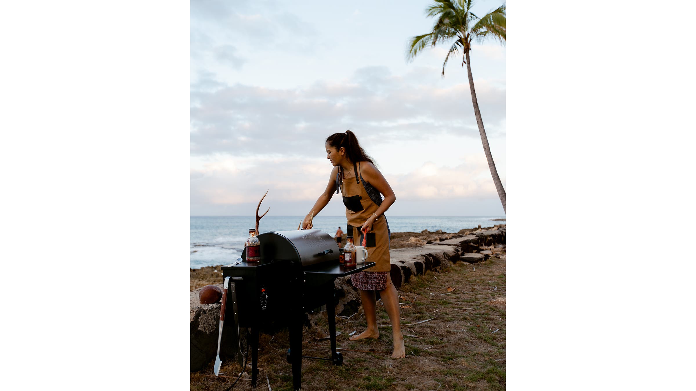 Kimi Werner grilling on a beach.