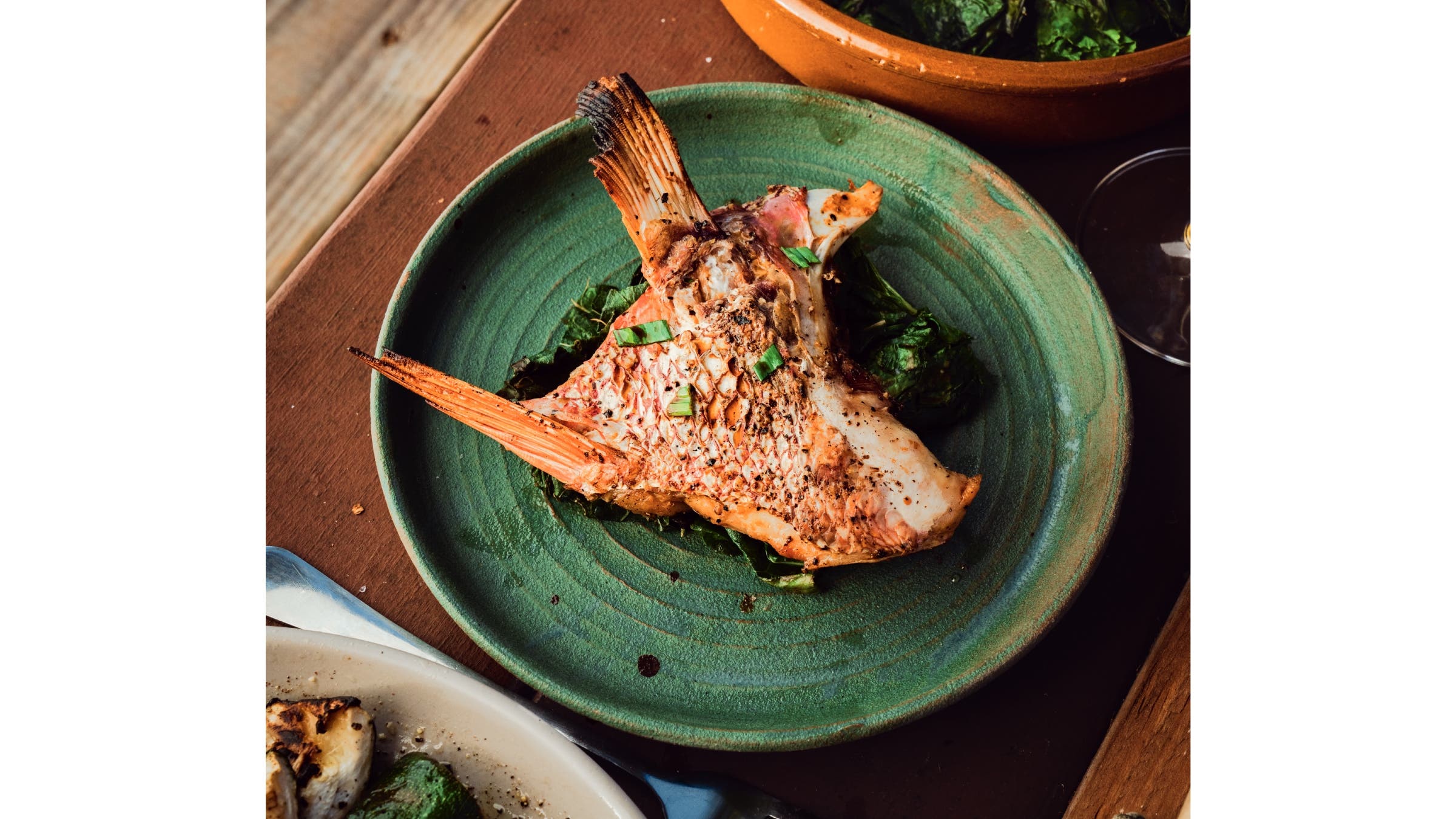 Grilled fish collars on a plate.