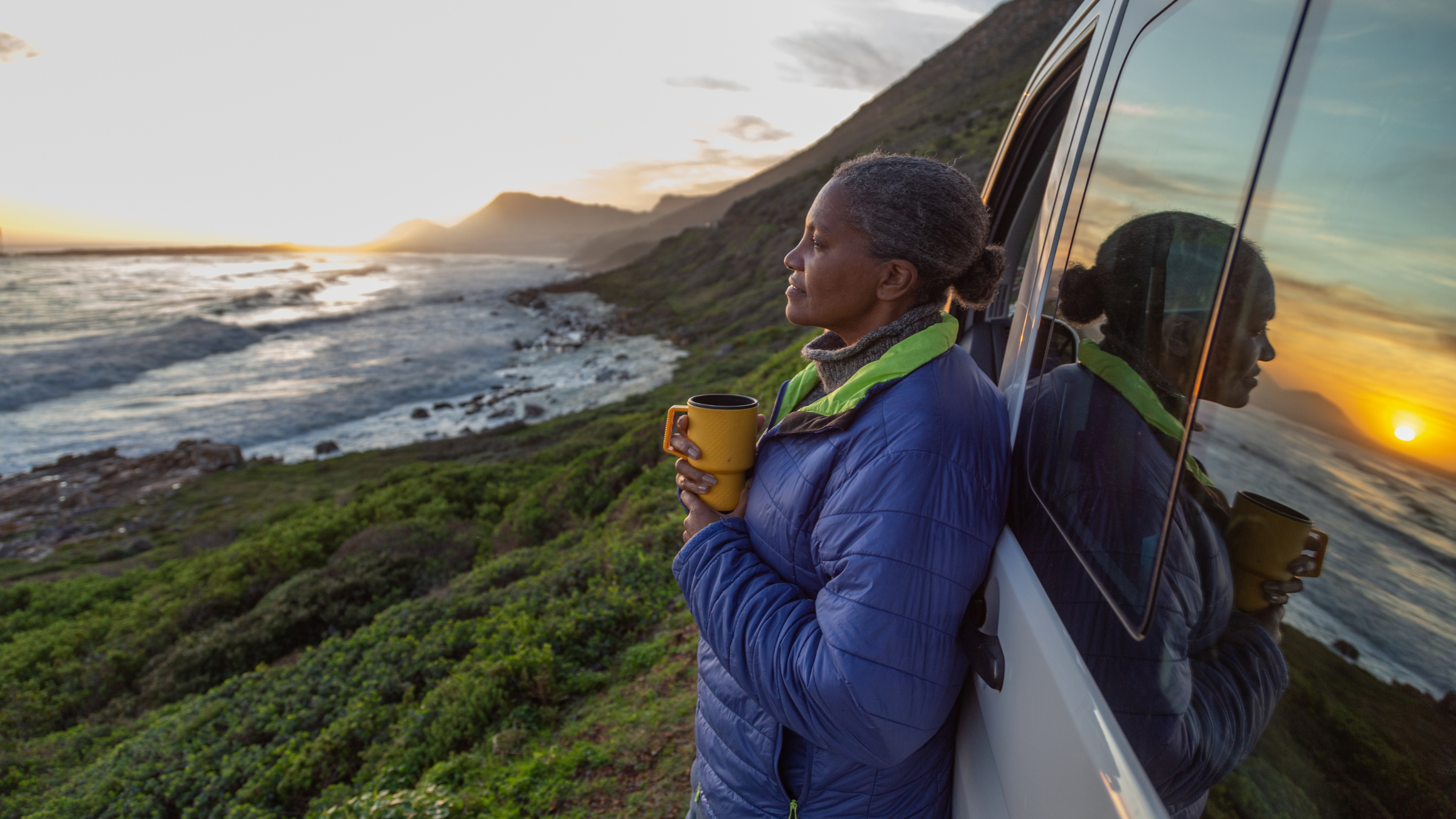 woman enjoying the coast in celebration of Earth Day 2026
