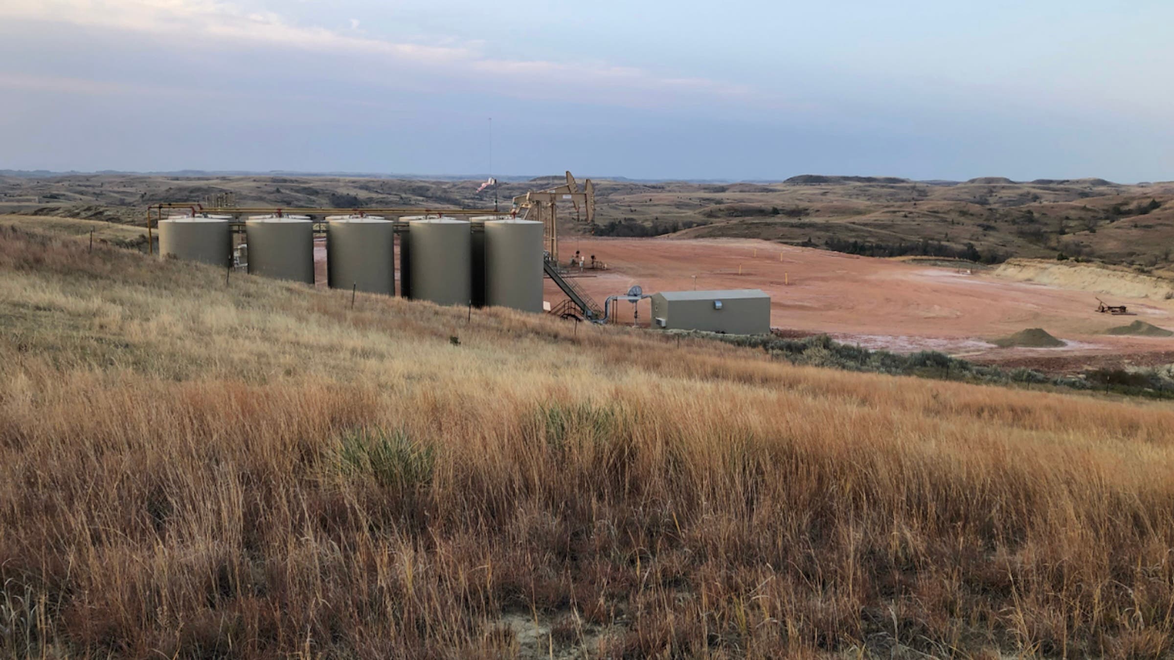 Tanks and pump jacks visible from the trail, near mile marker 78