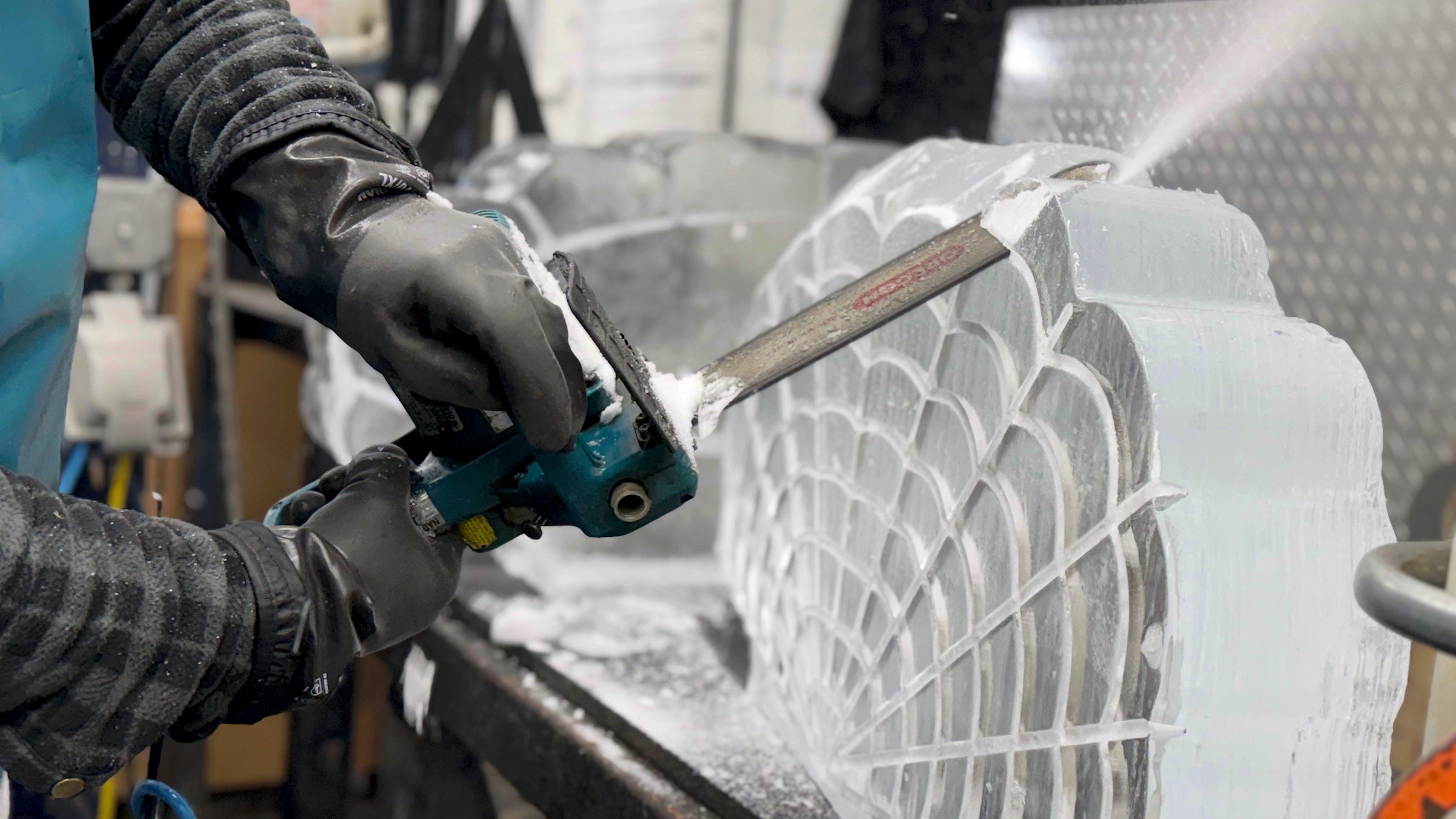 Max Barajas, the owner of Nadeau’s Ice Sculptures, carves a shell