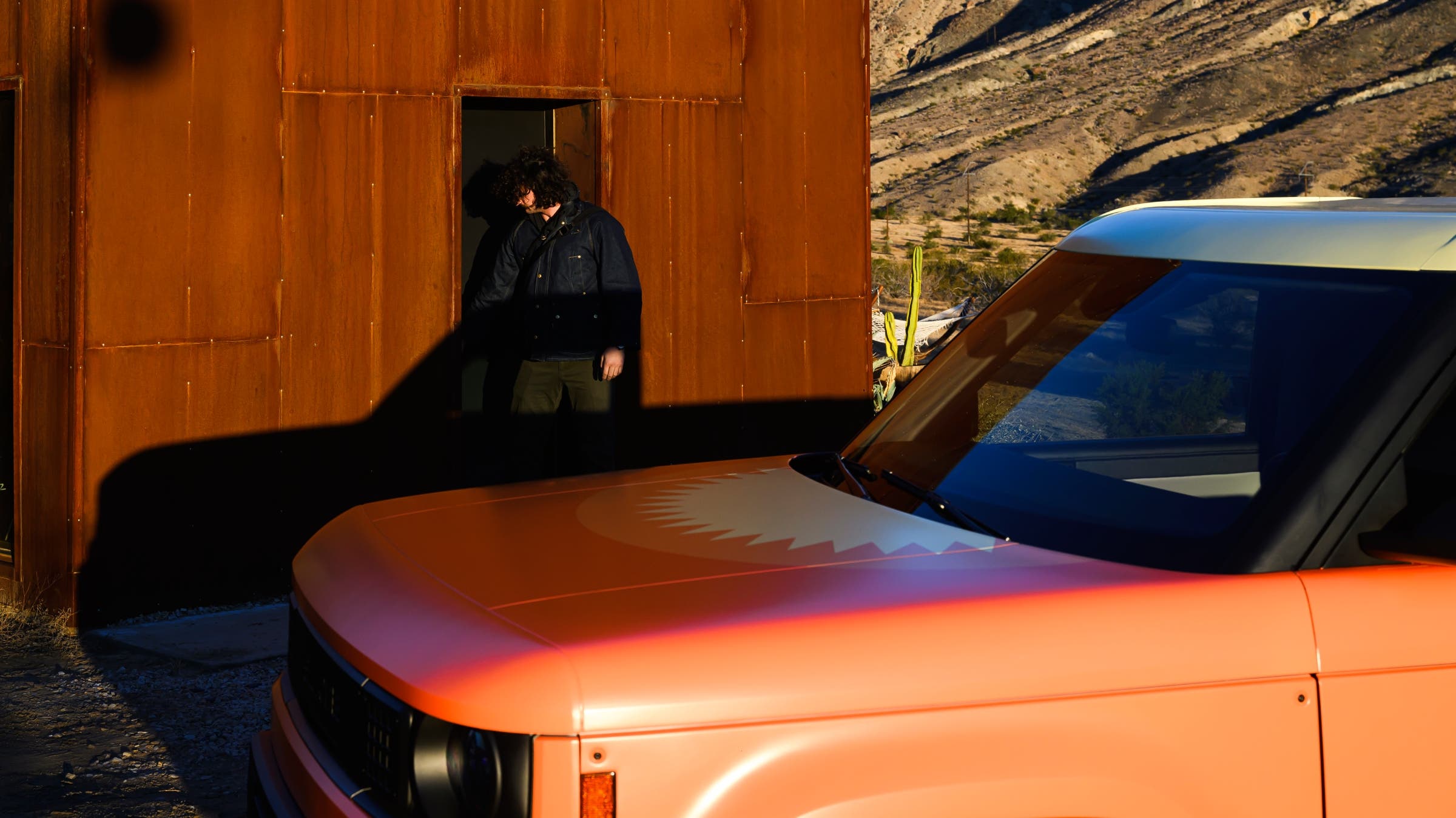 The Slate truck parked in front of a rust-red building.