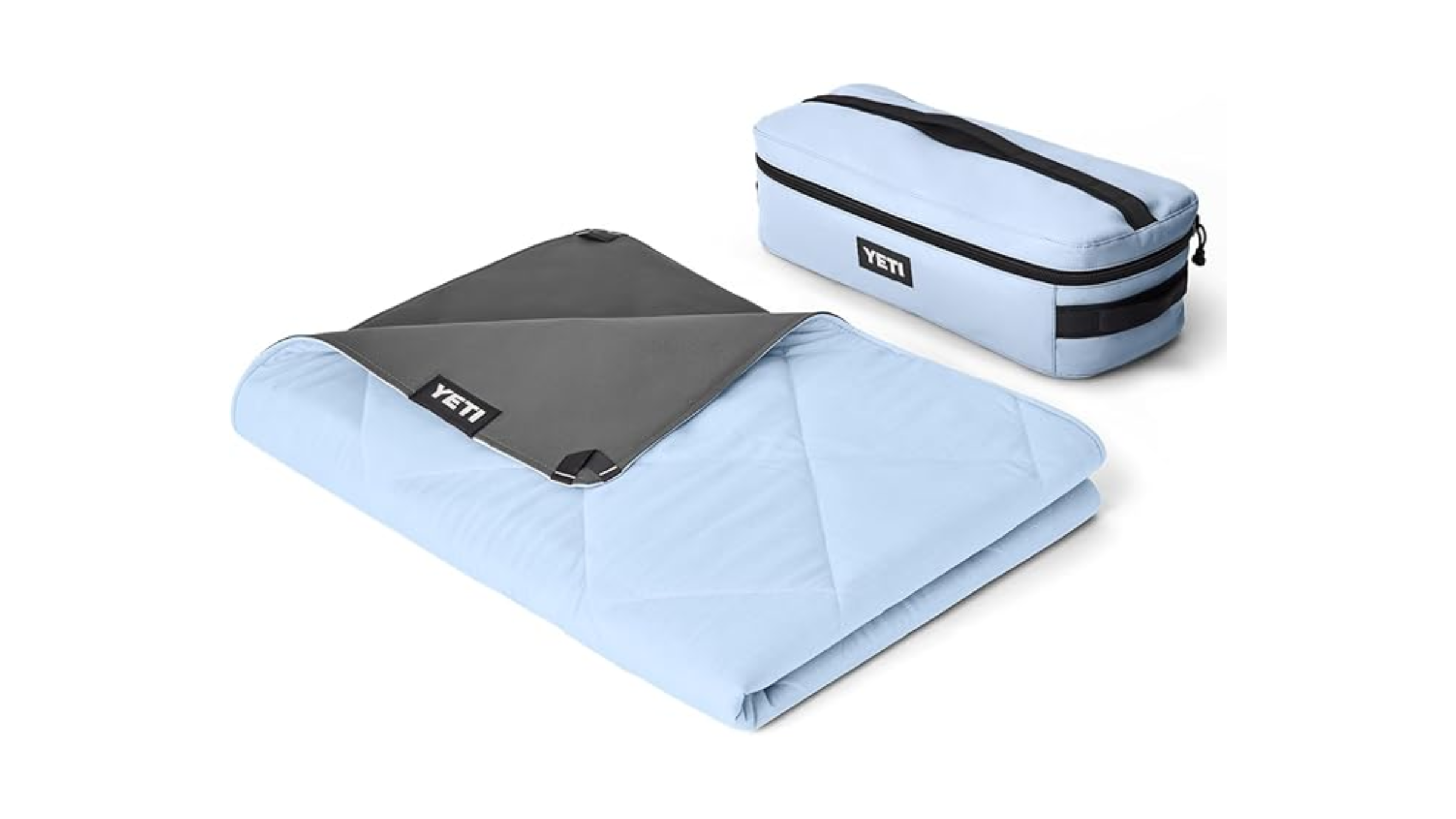 A Big Sky Blue YETI Lowlands Blanket shown folded next to its matching travel bag, a top pick for an Amazon YETI deal on camping gear.