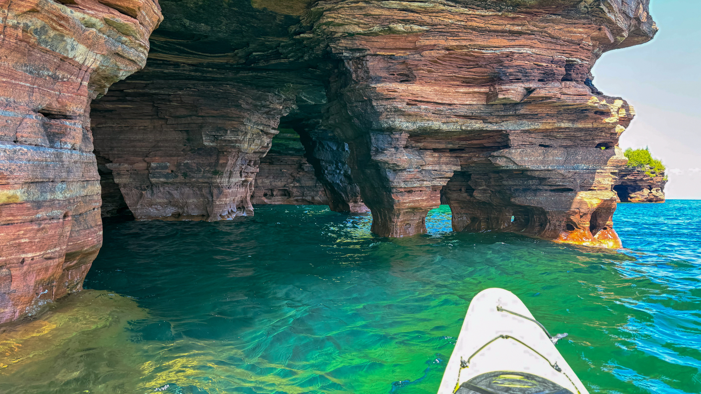 A person kayaking the sandstone caves of the Apostle Islands