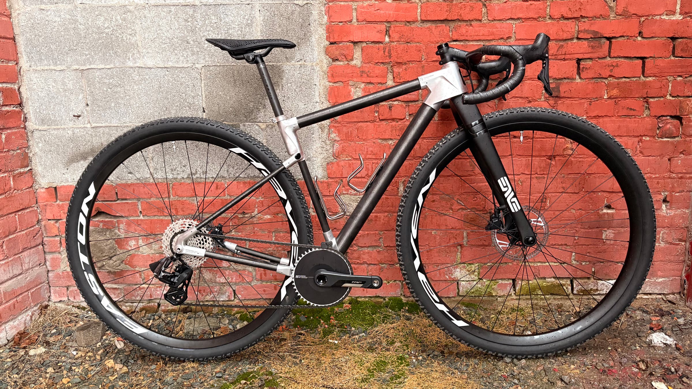 Faction Bike Studio Atlas gravel bike with 32" wheels in front of brick wall