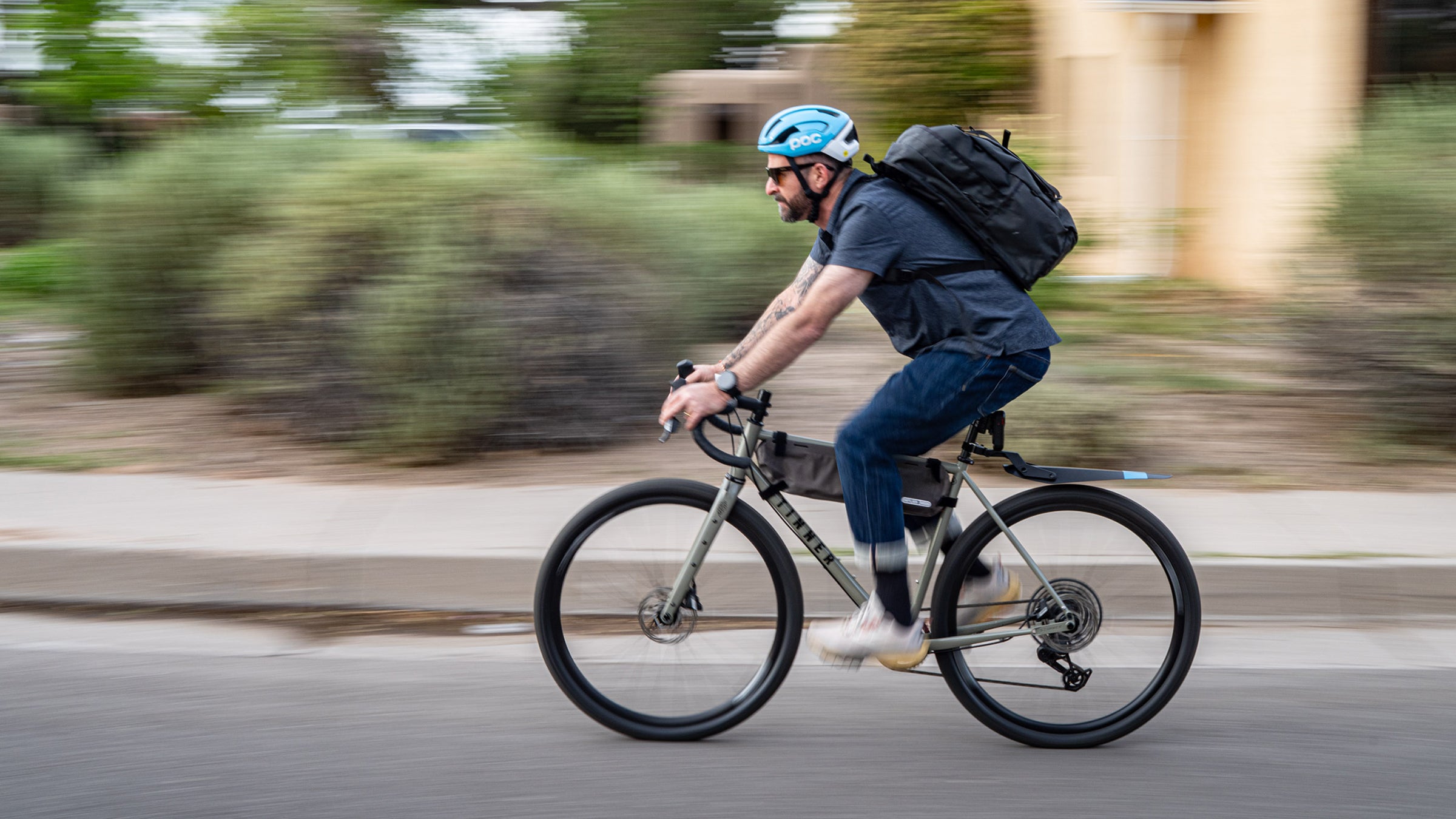 Author Jakob Schiller riding his bike to work wearing bike commuting gear and accessories for a safer, more comfortable ride