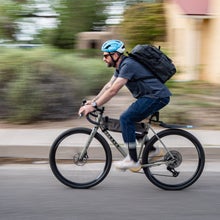Author Jakob Schiller riding his bike to work wearing bike commuting gear and accessories for a safer, more comfortable ride