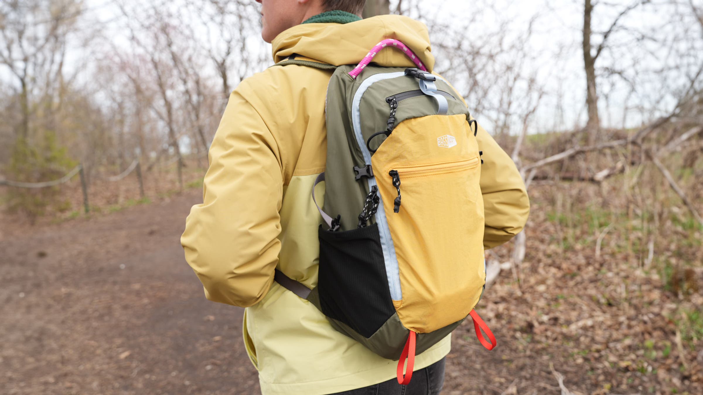 Bird watcher in woods wearking Bagsmart Faro Lite 0.4 backpack, an essential piece of the best birding gear