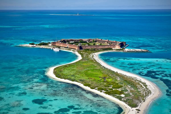 an aerial image shows fort jefferson of dry tortugas national park in florda. fort walls surrounded by ocean