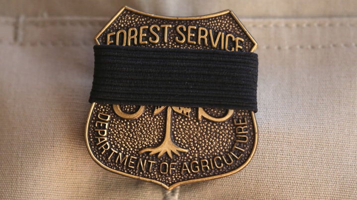 A black mourning band covers the badge of a U.S. Forest Service officer during a memorial service for fallen Big Bear Interagency Hotshot Charles Morton, a firefighter who was killed battling the El Dorado wildfire, on September 25, 2020 in San Bernardino, California