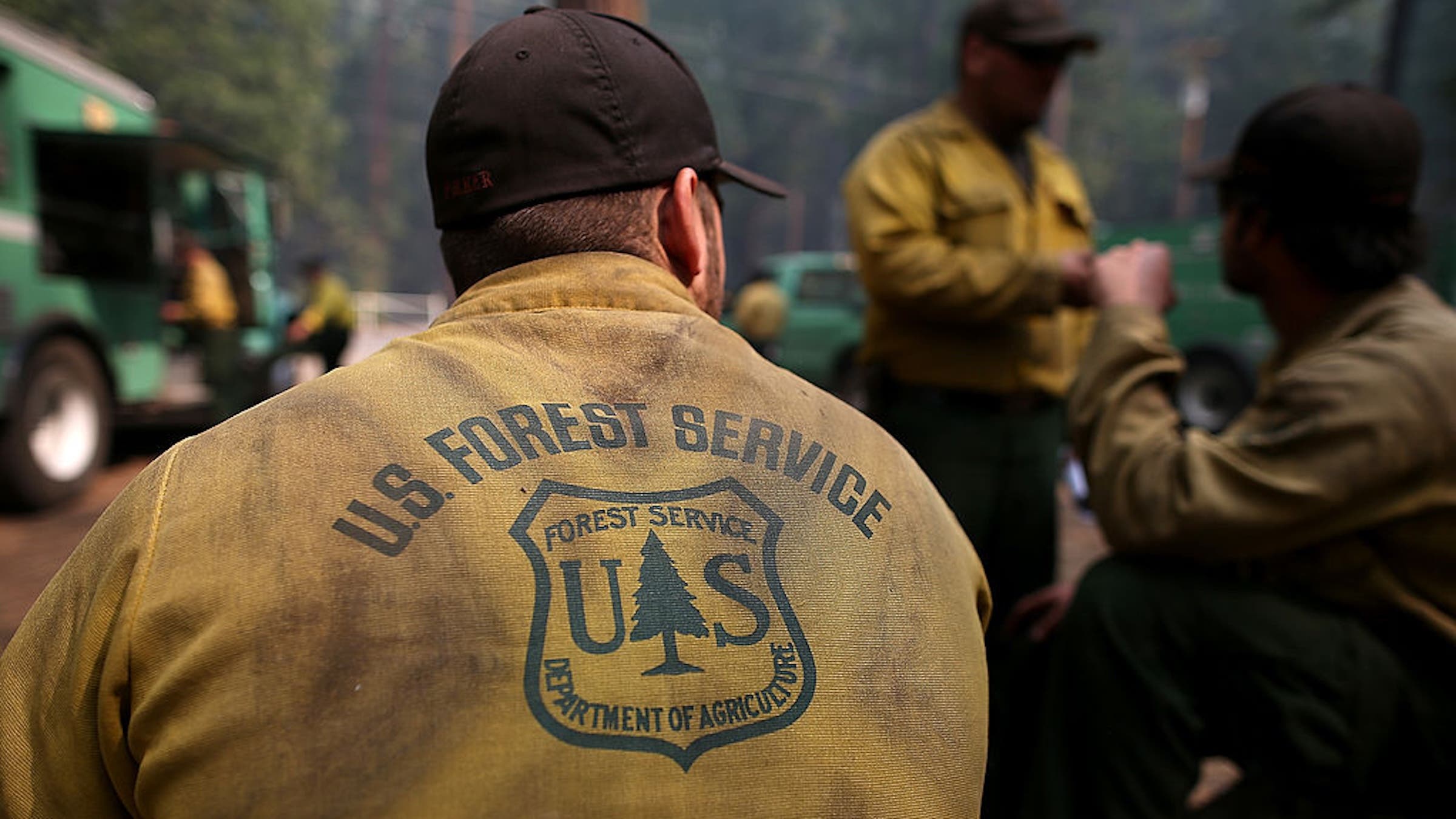 GROVELAND, CA - AUGUST 25: U.S. Forest Service firefighters take a break from battling the Rim Fire at Camp Mather on August 25, 2013 near Groveland, California. The Rim Fire continues to burn out of control and threatens 4,500 homes outside of Yosemite National Park. Over 2,000 firefighters are battling the blaze that has entered a section of Yosemite National Park and is currently 7 percent contained. (Photo by Justin Sullivan/Getty Images)