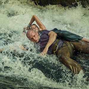 taron and charlize in water on set of 'Apex'