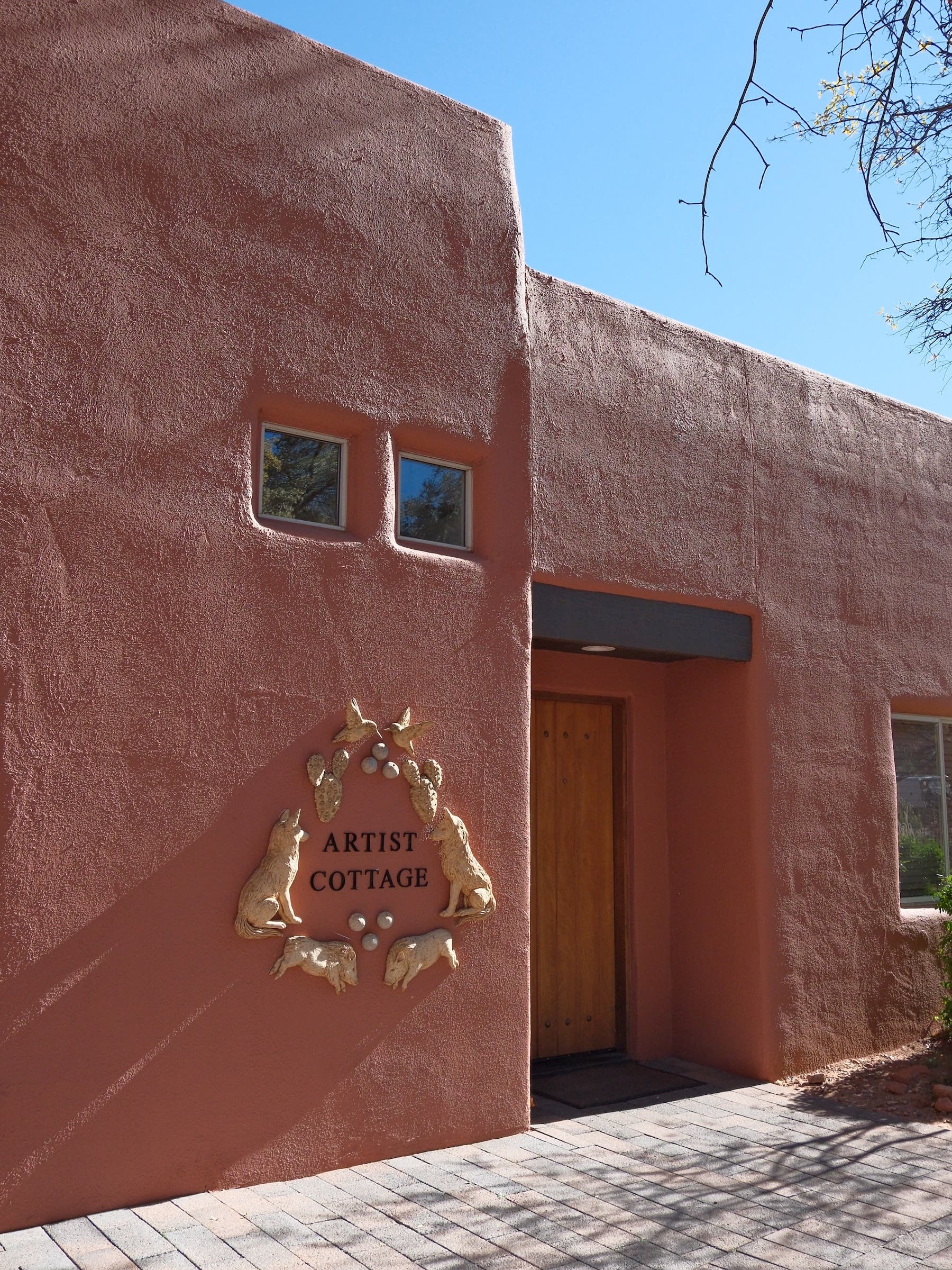 exterior of Enchantment's Artist Cottage, a southwestern building made of red stucco