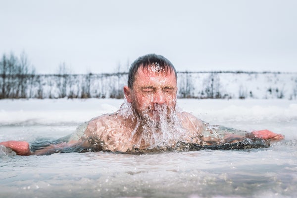 Man doing a cold plunge in an ice hole, coming up from under the water, doing a cold plunge mistake by plunging in too-cold of water