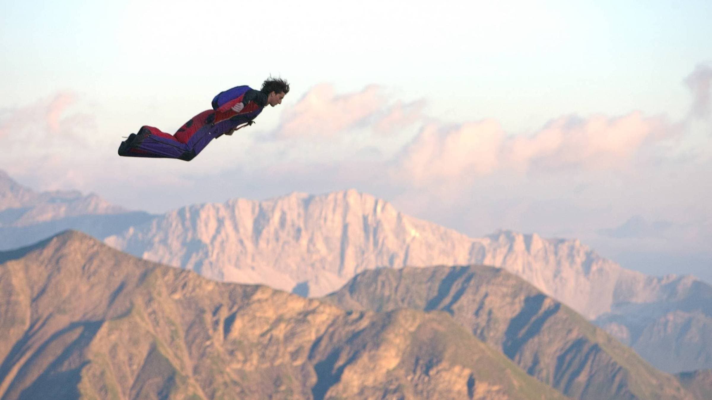 Dean Potter flys through the sky in a wingsuit