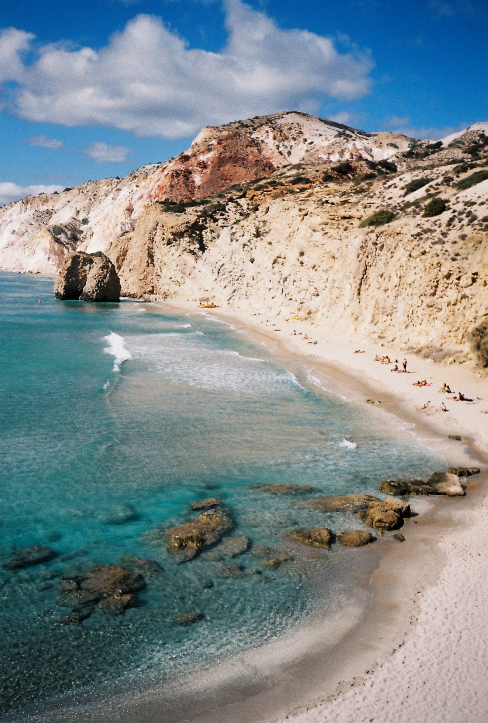 coastline in greece with light colored cliffs and turquoise water