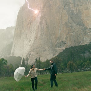 Photo captured by erica houck shows the couple with a clear umbrella holding hands in a rainstorm in front of yosemite's el capitan as a lightning bolt strikes