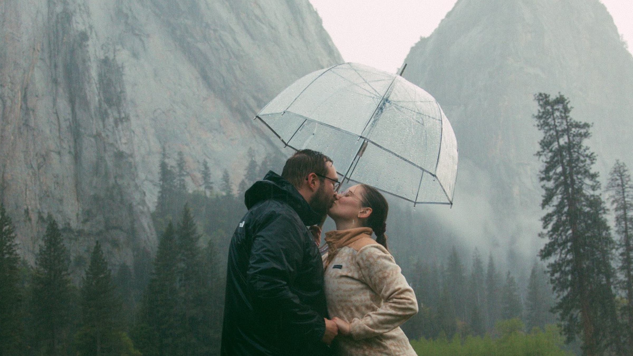 Erica Houck captured this photo of a german couple under an umbrella in front of yosemite's tunnel view