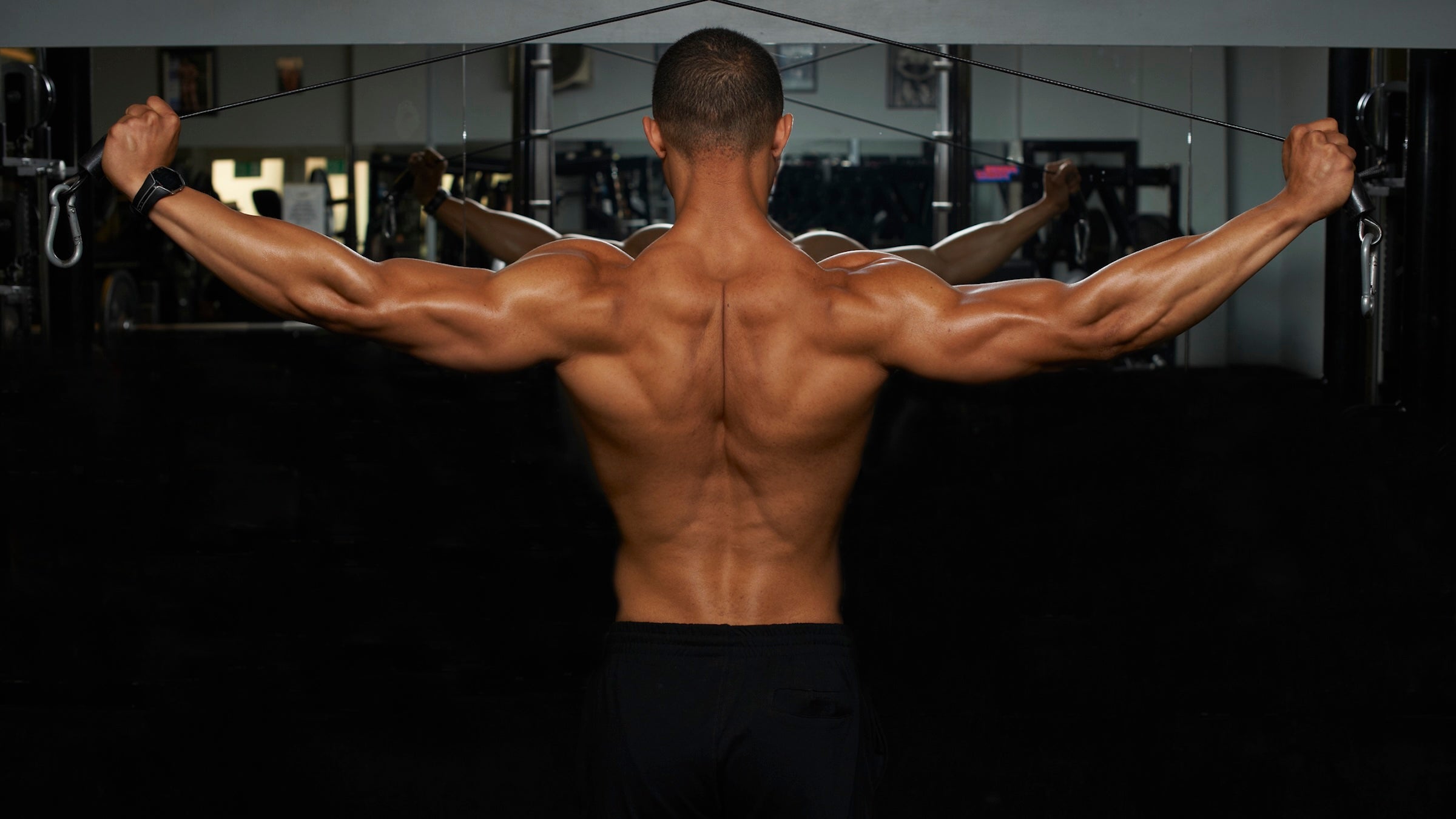 man's strong back with weights
