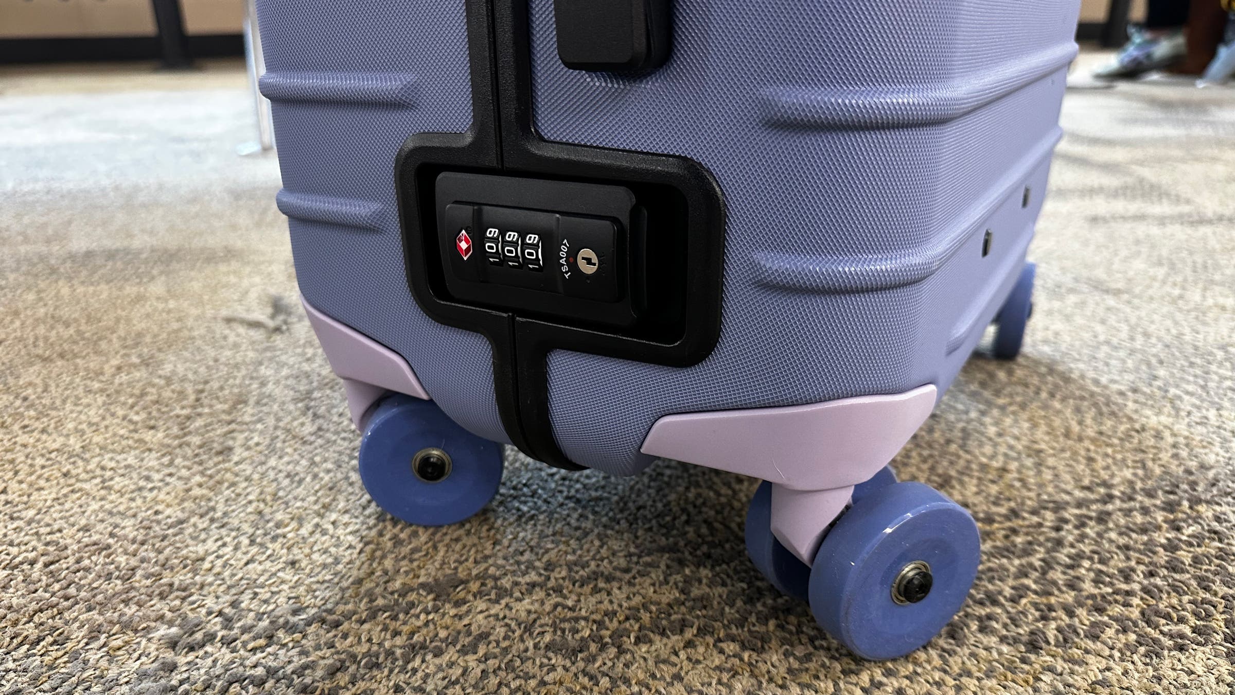 Cotopaxi hard-sided carry on suitcase includes a combination lock to keep items inside secure while at airport.