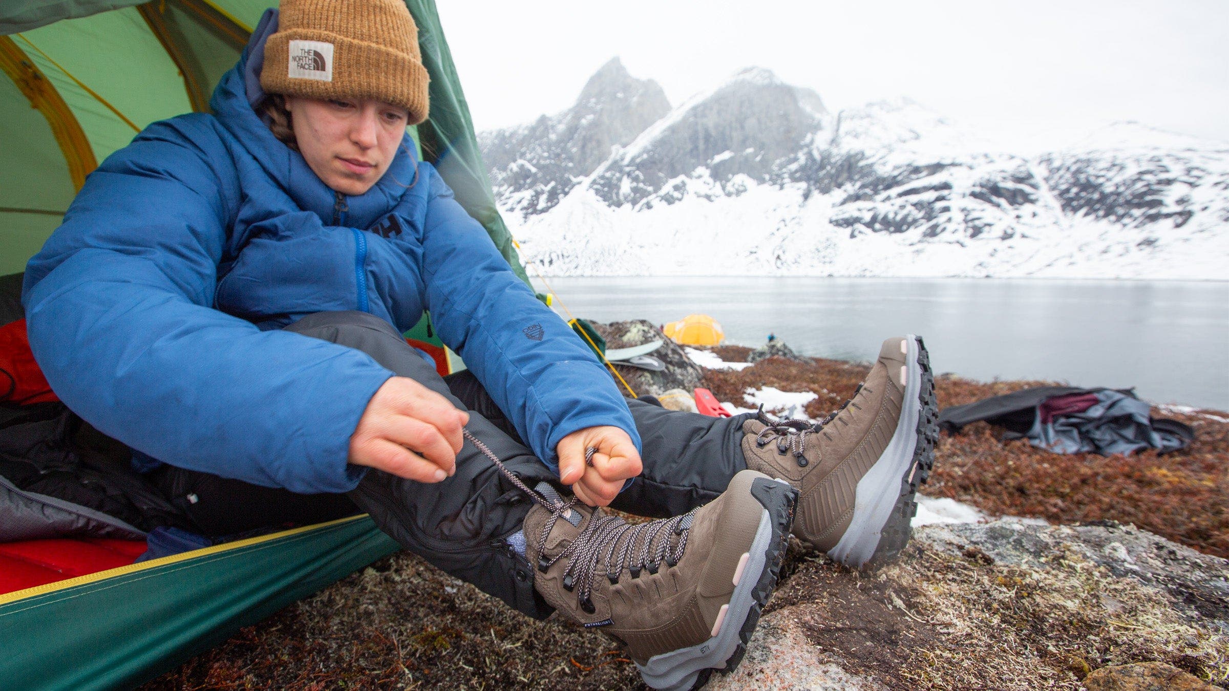 a woman tying her hiking boots