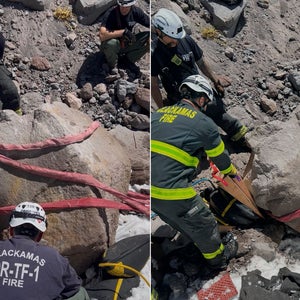 Search and rescue personnel use a ladder system to lift a 16,000 pound boulder off of a climber in Mount Hood