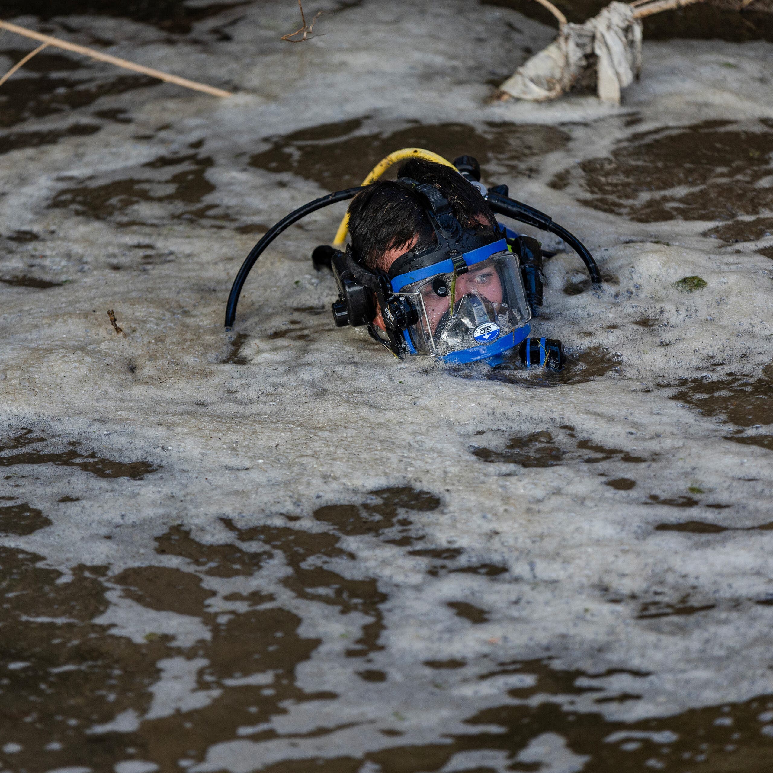 A recovery diver descends into the Guadalupe River
