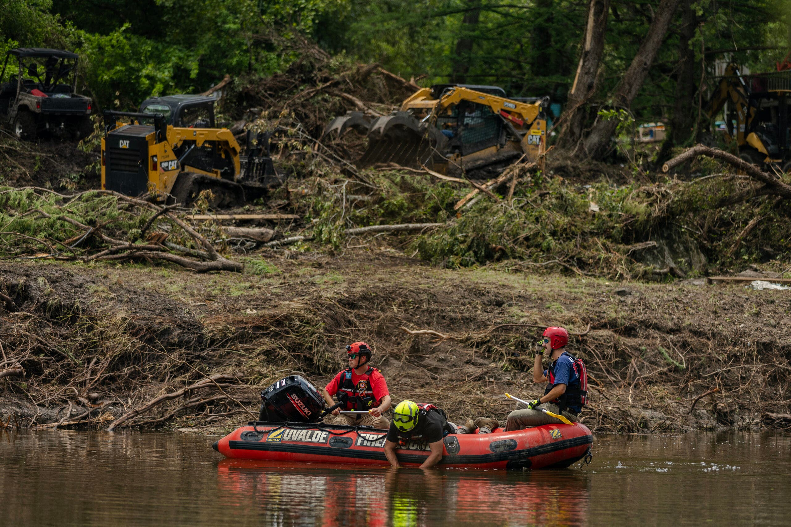 Recovery crews float on a raft