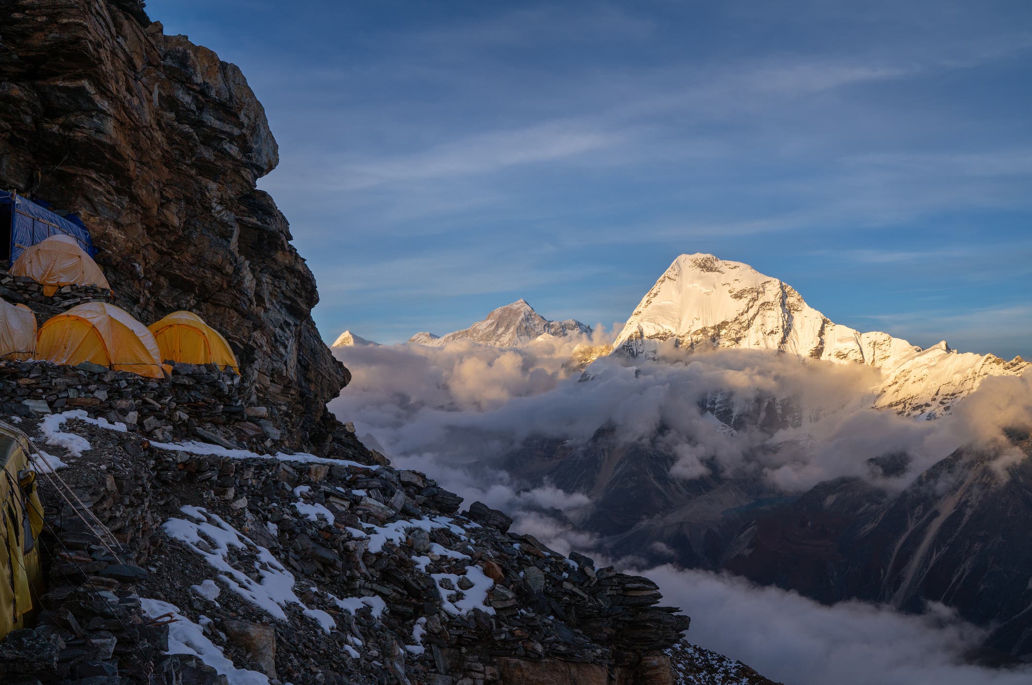 mountaineering tents shown along a ridgeline with makalu in the background