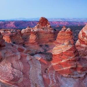 Dramatic red rock cliffs of Coyote Butter in Grand Staircase-Escalante photographed against a blue sky