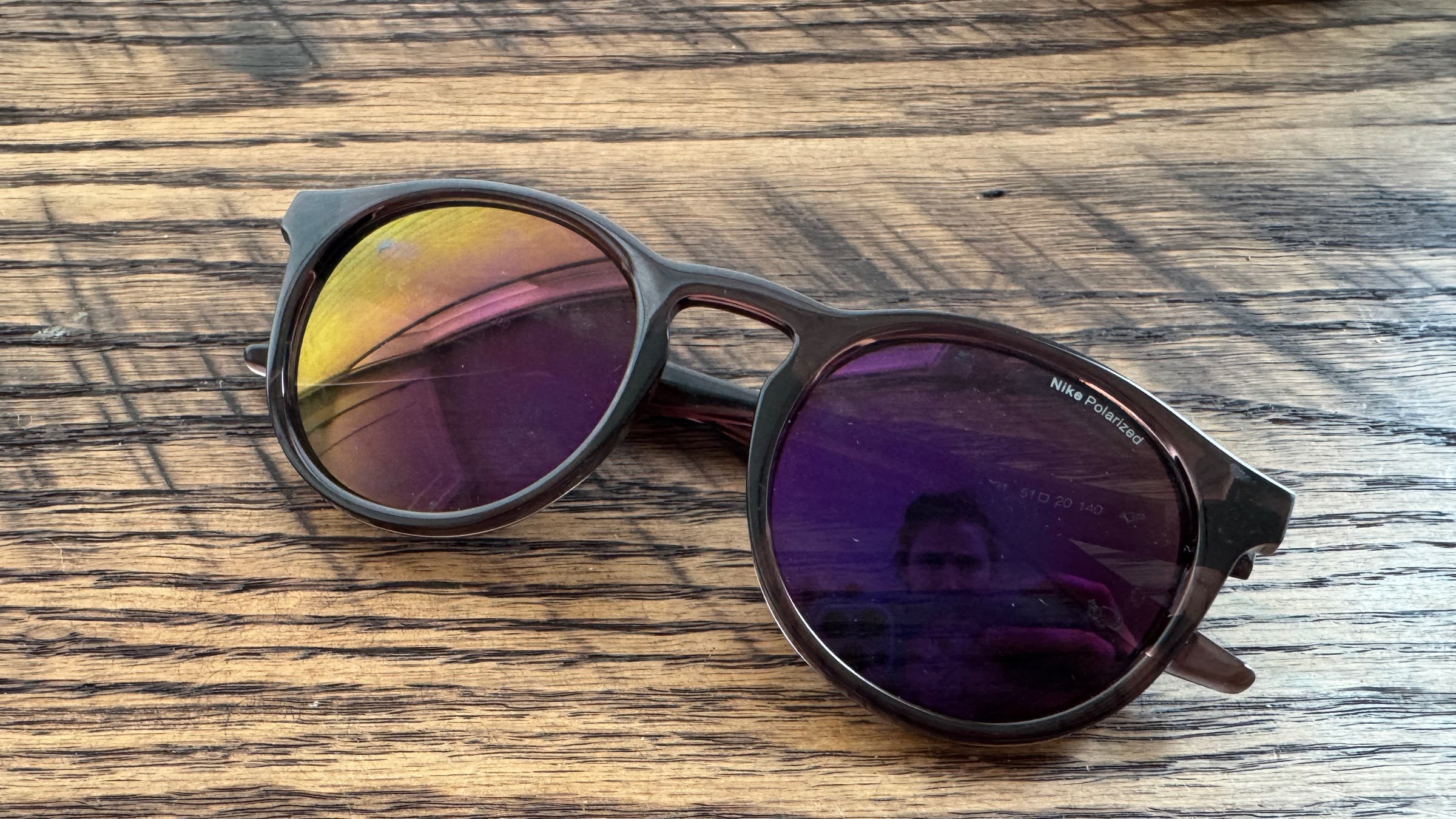 Tester image of Nike Swerve sunglasses on hardwood floor