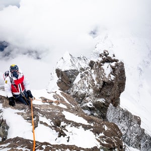 tim howell seen atop the snow-covered peak of Lhotse with climbing gear and supplemental oxygen