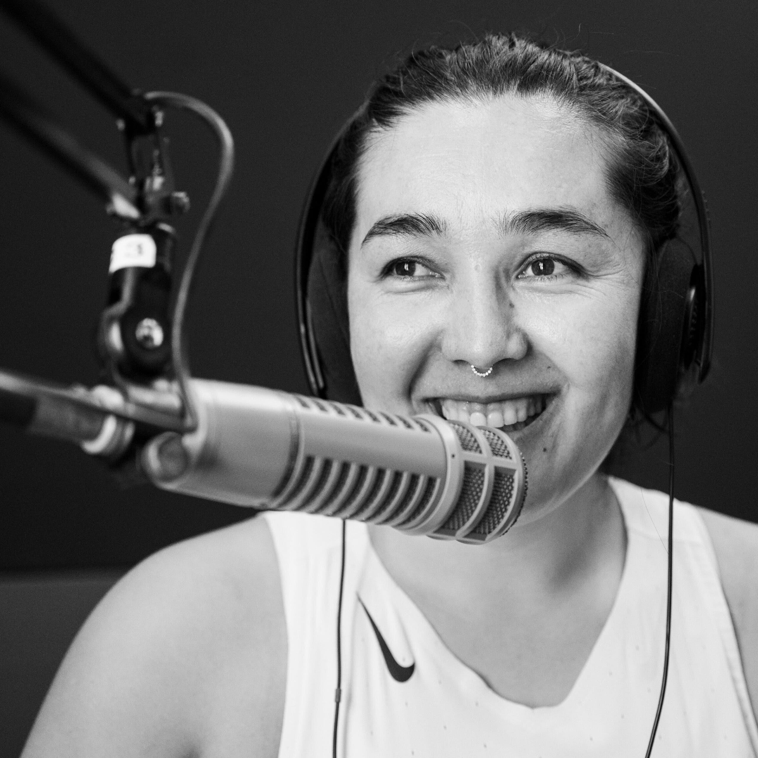 A woman in front of a microphone