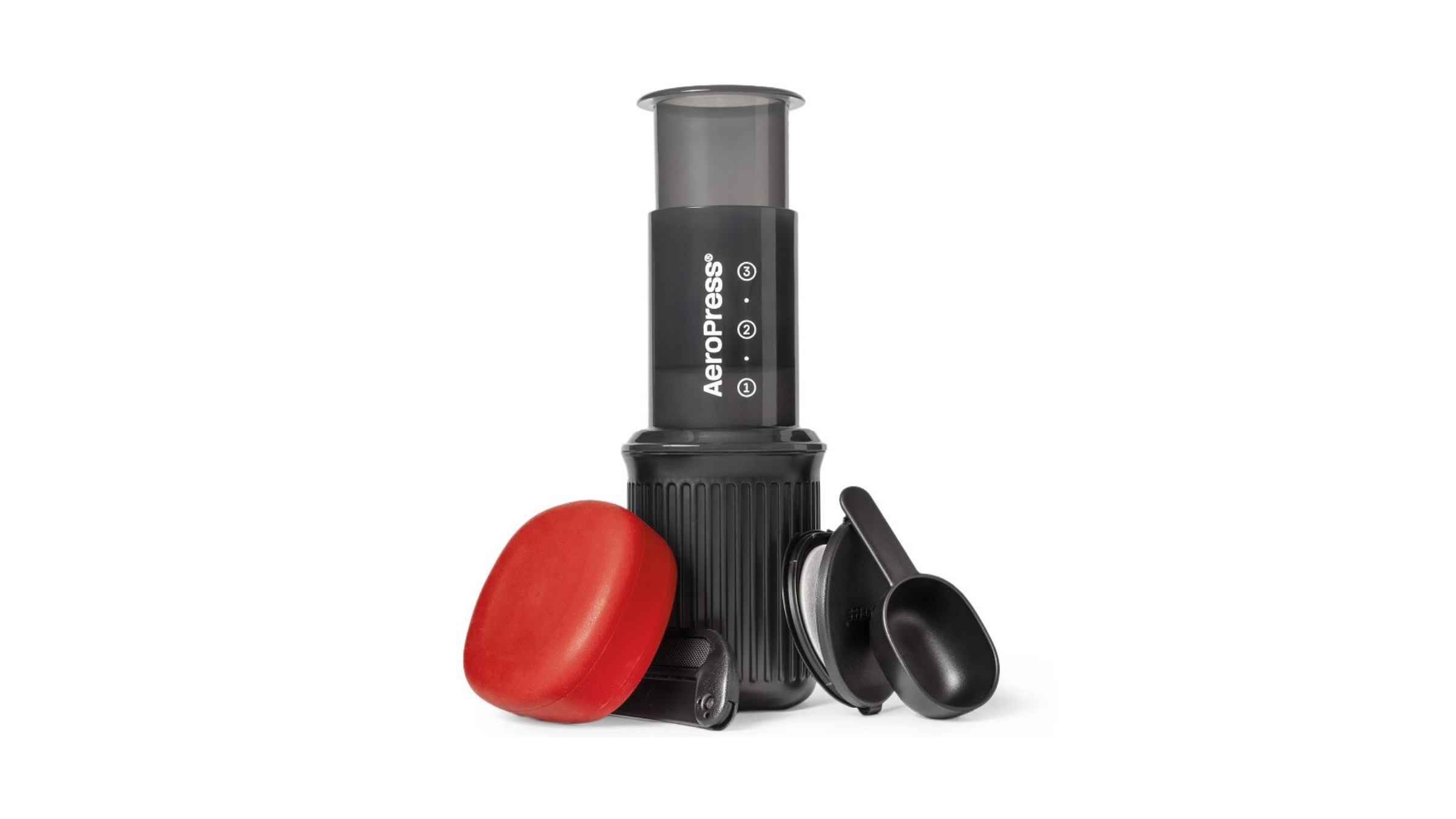 AeroPress Go travel coffee press displayed with its compact nesting components, including a black plunger, a red silicone lid that doubles as a mug, a scoop, and a filter holder, making it an ideal setup for brewing camp coffee.