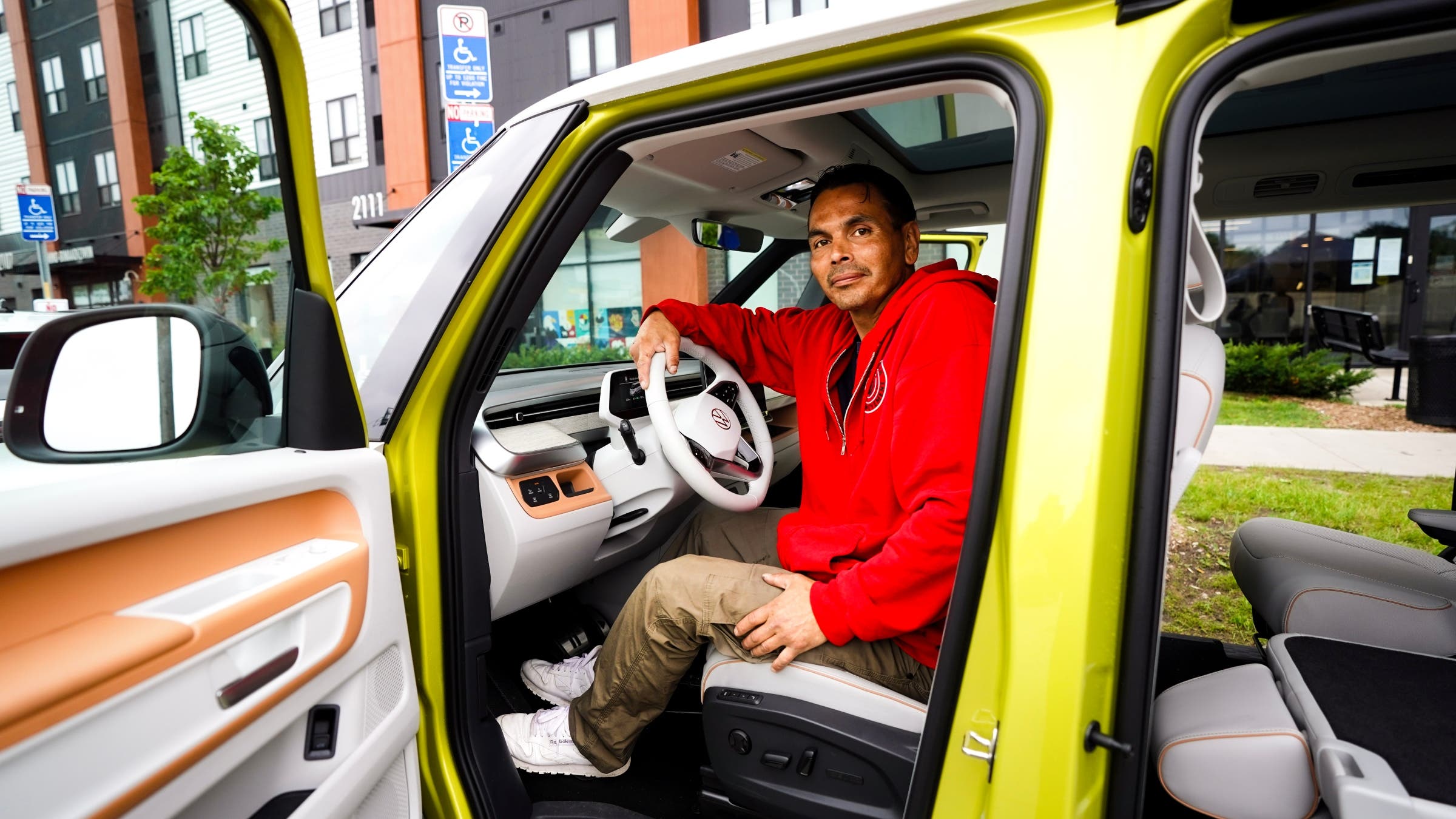 A man sitting in an all-electric car.