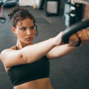 Fitness woman, gymnast ring and woman doing exercise workout , strength training and body wellness routine. Strong sports female or athlete with dip rings for power, self care and a healthy lifestyle